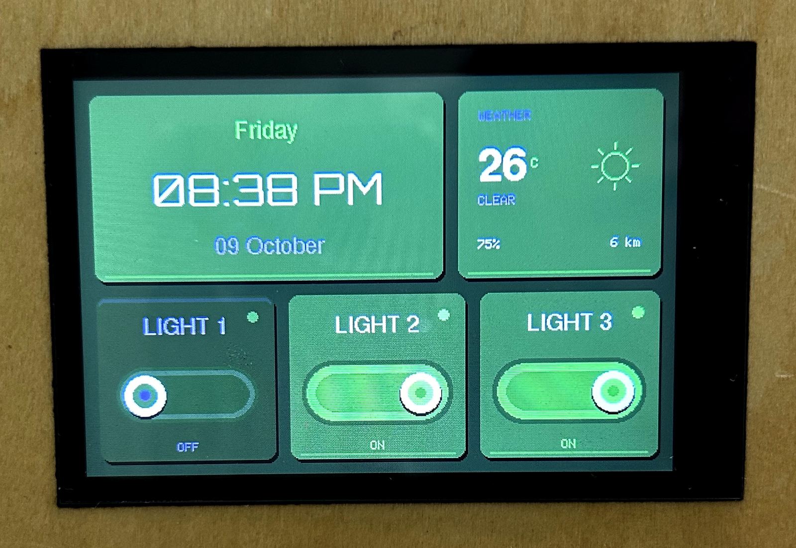Close-up of NT-01 home screen — clock, weather and light switches